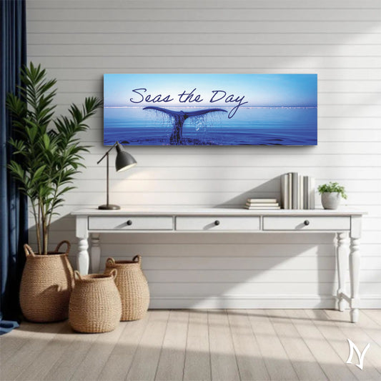Panoramic wall art of a whale tail in the ocean with 'Seas the Day' text, displayed in a room with a white desk and decor.